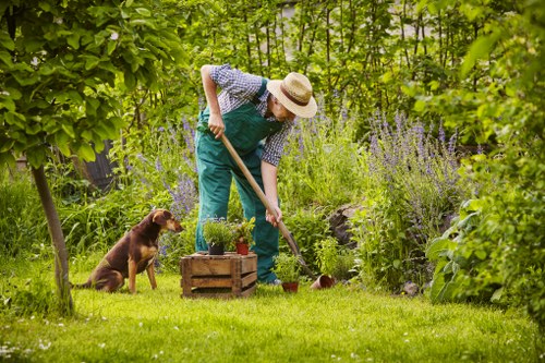 Gardeners Tottenham team beside green waste bins