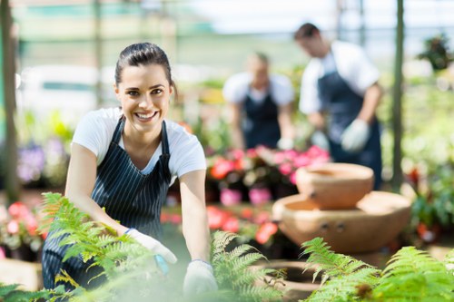 Gardener putting on protective gloves and high-visibility vest